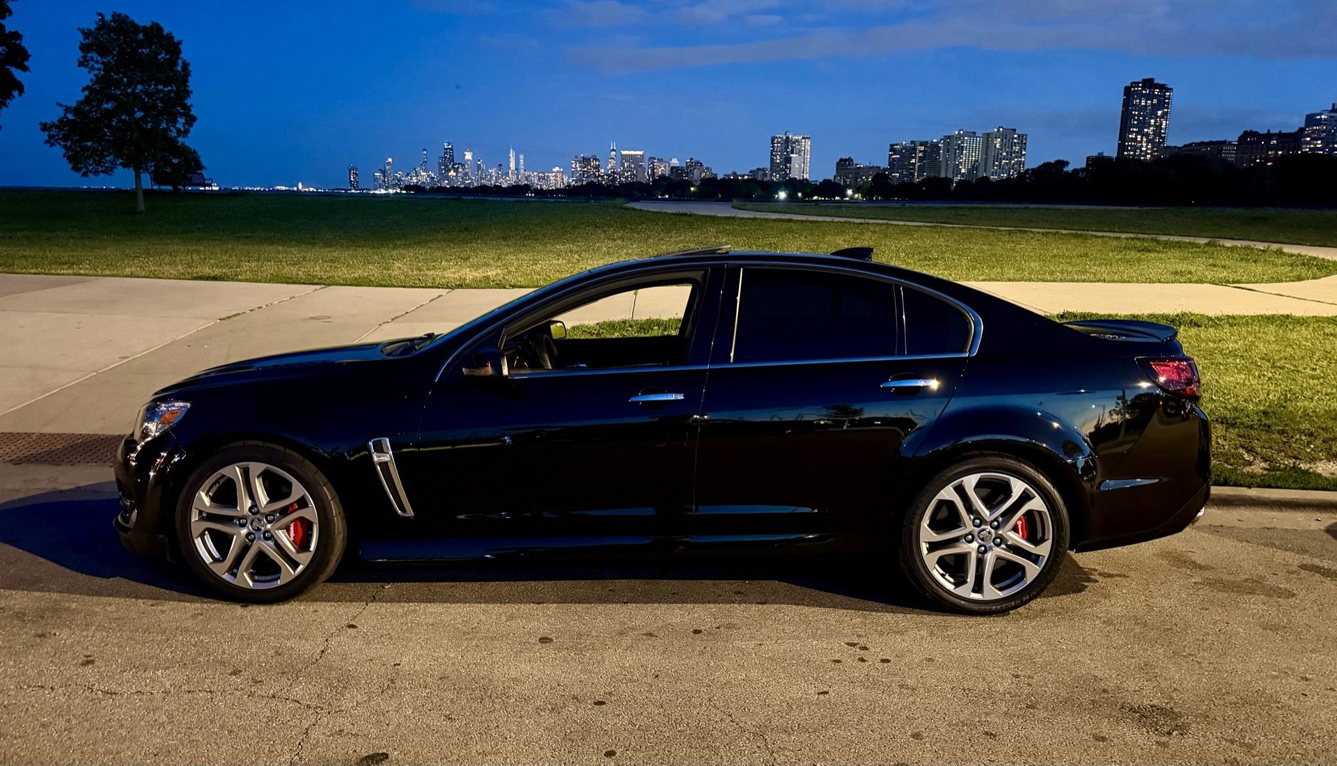 2017 Chevy SS at Montrose Harbor, Chicago at dusk with the skyline behind it